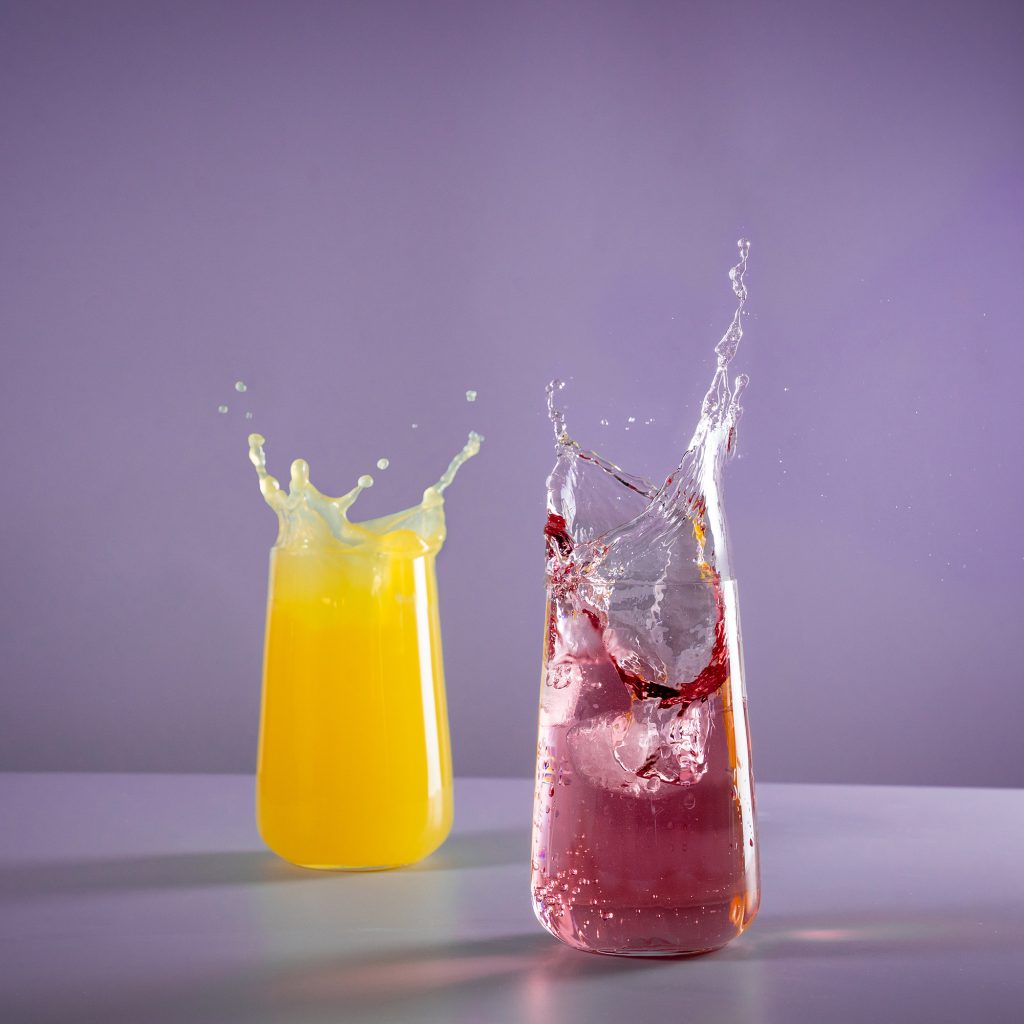 Splash shot of two soft drinks.